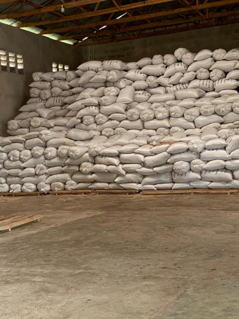 Divergent Tanzania warehouse team stacking agricultural commodity bags on pallets in Mkuranga